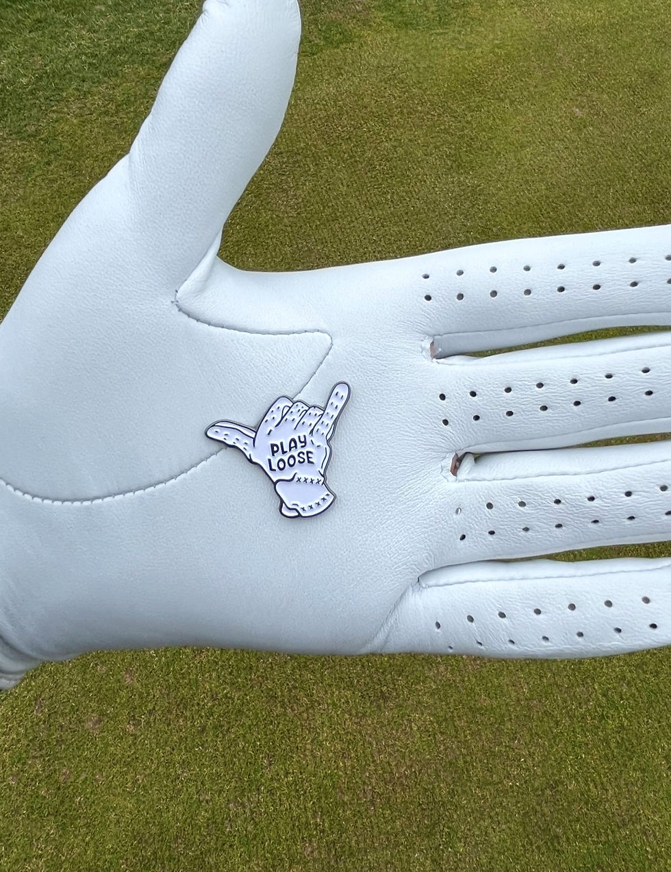 Play loose relaxed golf ball marker on white golf glove