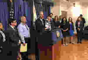 City Attorney Mike Feuer at podium flanked by members of Blue Ribbon Panel on School Safety