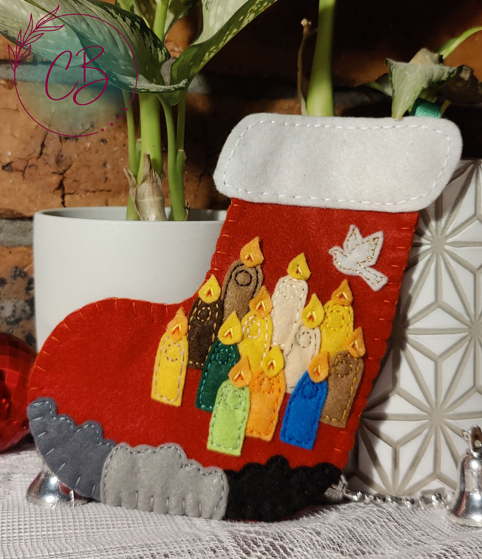 Felt Christmas stocking with colourful figures and a white dove, set against a brick wall and plant in a white pot. Cosy mood.