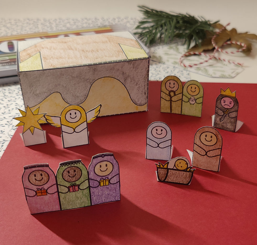 Nativity characters coloured in and cut out from paper with a box providing the backdrop for acting out the nativity story