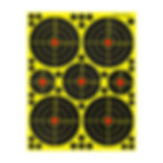 Shooting targets: six black bullseye circles on yellow paper