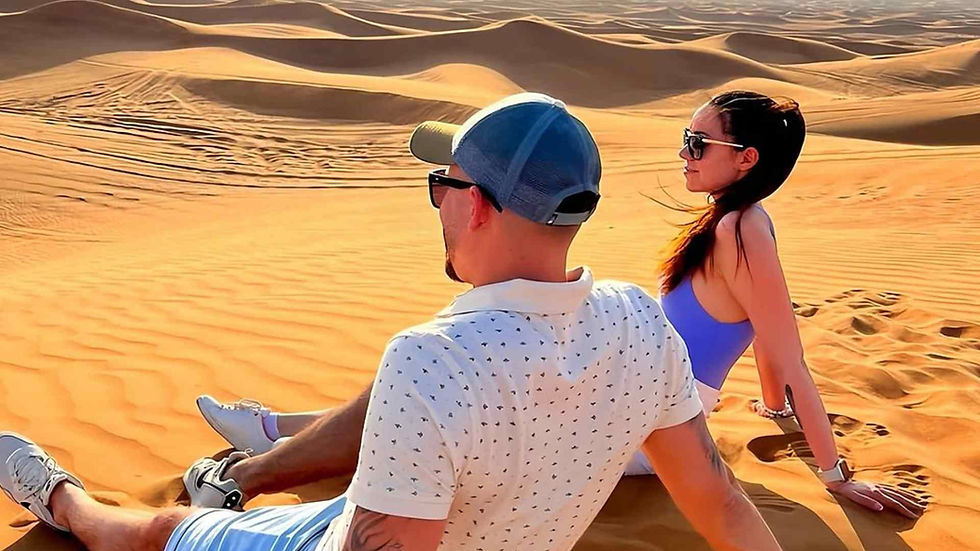 Tourists are sitting in Lahbab Desert in Dubai
