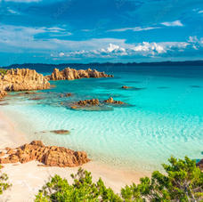 Beautiful beach with crystal clear blue waters and rocky Mediterranean terrain on the Emerald Coast in the Archipelago of La Maddalena, Sardinia, Italy.