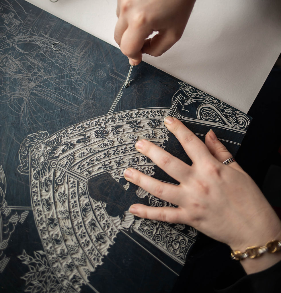 Hands carving intricate patterns on a dark block. Detailed floral and geometric designs. Focused and artistic mood. Linocut block being carved by relief printmaker Moatzart with linocut carving tools