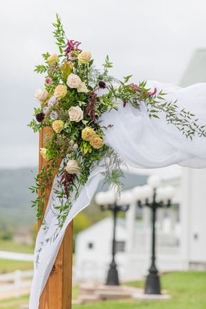 Wedding arch decorated with blush pink garden roses at the Manor at Breckenridge 