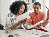 a young couple reviewing papers