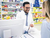 a pharmacist providing medicine to a patient
