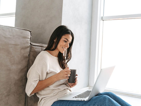 A young woman looking at her computer and browsing medical tourism doctors social media