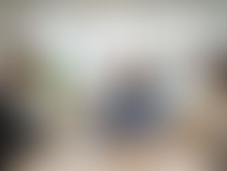 a woman and two men having a meeting in an office