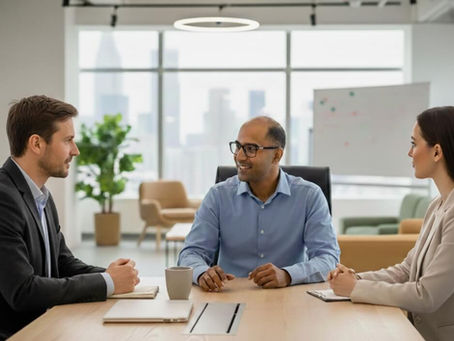 a woman and two men having a meeting in an office