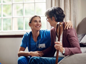 a smiling nurse helping a senior woman at a meditel