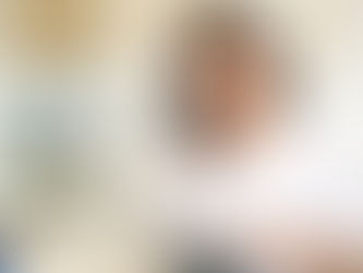 a woman looking at her ipad and holding coffee in her hand