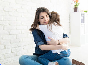 a woman hugging her daughter
