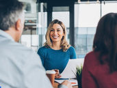 a smiling medical agent with her customers