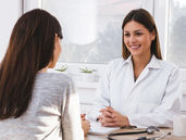 A doctor consulting a patient emphatically