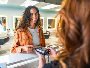 a young woman making a credit card payment at a clinic