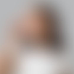 a young smiling woman touching her nose