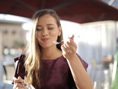 a young woman happily eating food