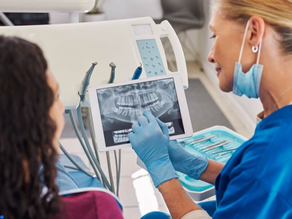 a dentist showing image results to her patient