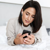 a woman browsing social media with her phone in her hand
