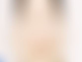 a young smiling asian woman putting moisturizer to her face 