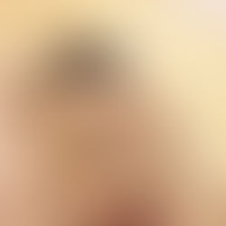 a man looking into his hair in the mirror