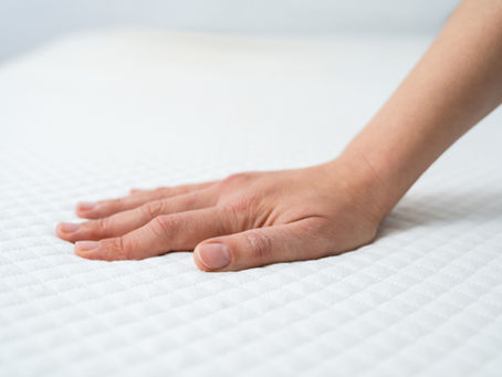hand resting on mattress