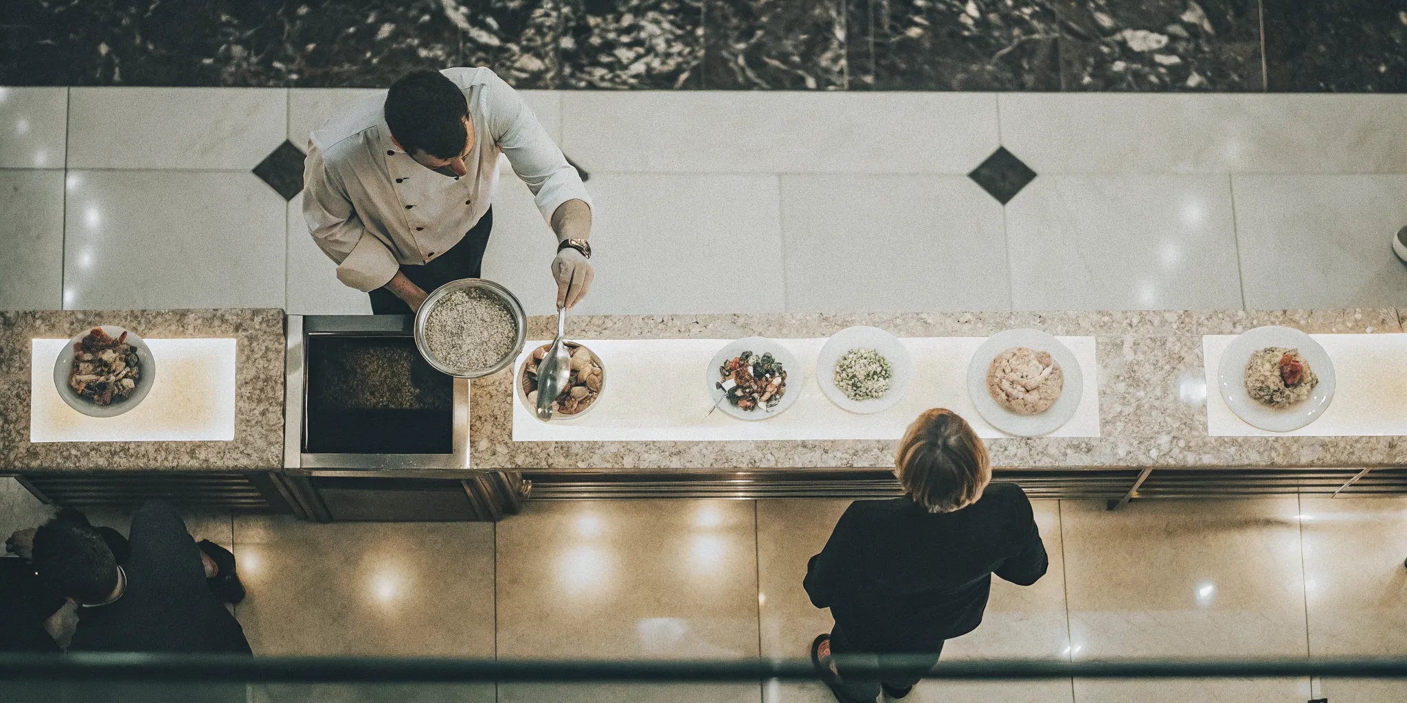 Chef finishing fresh pasta at a live action station for a San Diego corporate event