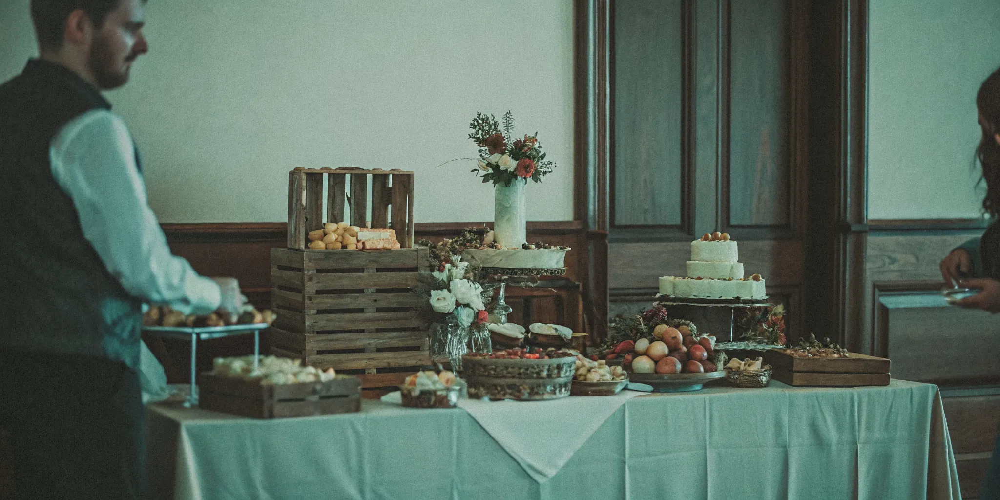 Elegant wedding grazing table with artisan cheeses, fresh fruits, and floral decor at a San Diego venue