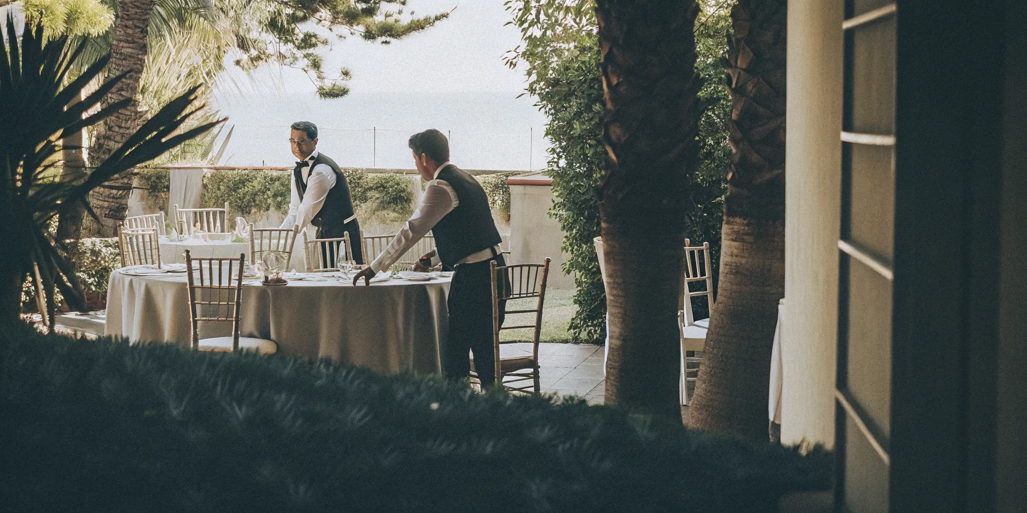 Professional catering staff preparing an outdoor San Diego wedding reception
