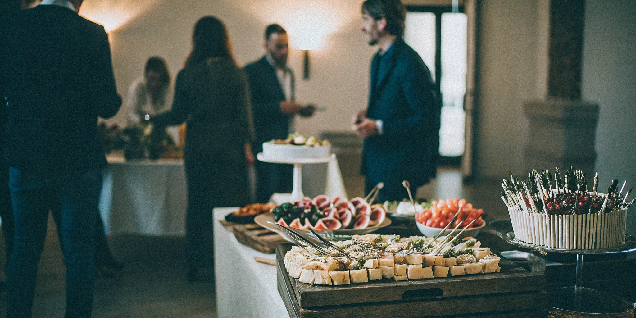 An elegant corporate event grazing table in San Diego with artisanal cheeses, fresh berries, figs, and flatbreads