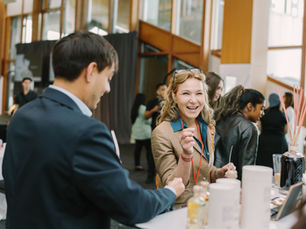 Smiling woman at a trade show experiential marketing booth