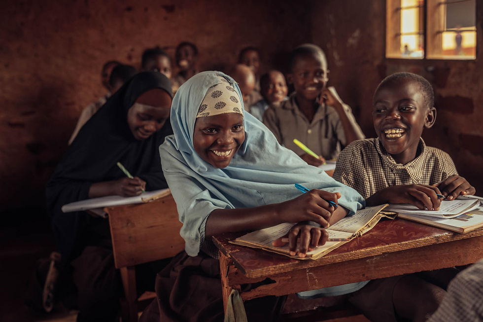 A female student smiles at a desk