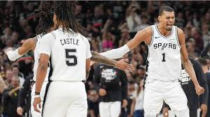 Eye-level view of a basketball court with the San Antonio Spurs logo at center court