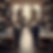 Luxury tailoring workshop with suits on mannequins, fabric rolls, and craftsmen working on bespoke menswear