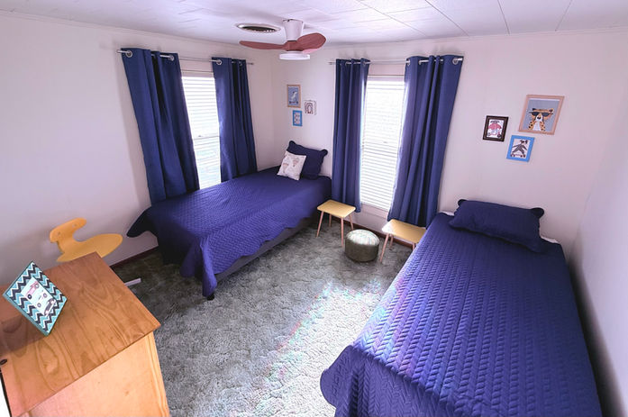 Bedroom with two twin beds and a small dresser