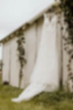 wedding dress hanging on a building