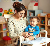 preschool teacher rocking infant