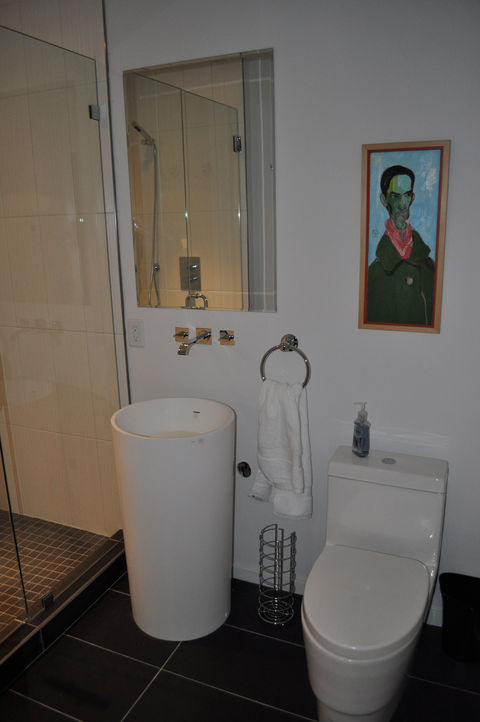 High-end bathroom renovation with freestanding custom sink, high end plumbing fixtures, Schluter waterproof membrane with custom tile and seamless shower glass surround