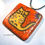 Thumbnail: Small Kitty Petroglyph Pendant - Red Coral Background