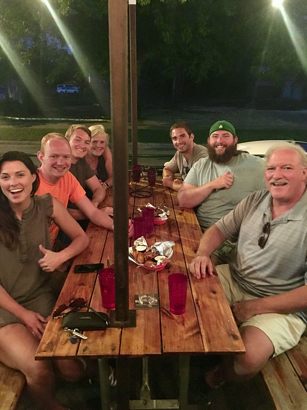 My family and I at a picnic table at a pizza restaurant in Texas, July 2018