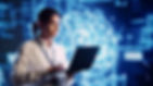 Person in a white shirt using a laptop with a glowing brain and AI text in the background, symbolizing technology and innovation.