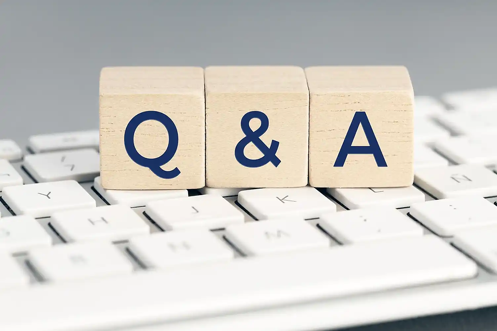 Wooden blocks with "Q & A" on a white keyboard. Blocks are light brown with dark blue letters. Clean, minimalistic design.