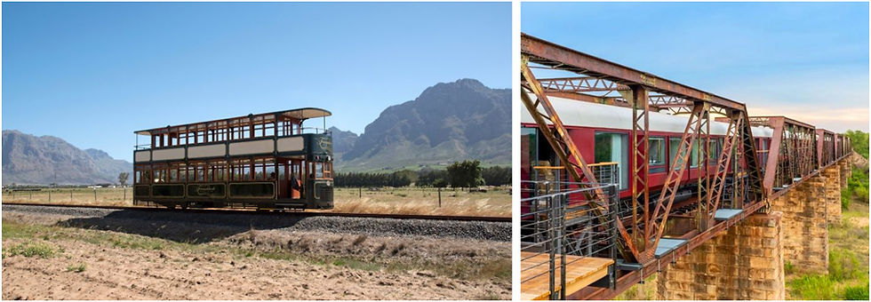Trem vintage verde com dois andares em paisagem montanhosa; à direita, trem vermelho em ponte metálica. Céu azul e clima pacífico.