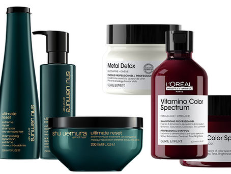 Produtos de cabelo: frascos e potes de Shu Uemura e L'Oréal em cores verde e vermelho. Rótulos com texto visível. Fundo branco.