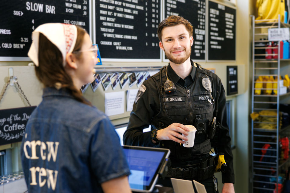 Soldotna Police officer in local coffee shop with barista