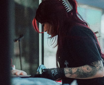 Kat Vargas (WoahKat) working on a fine line floral tattoo
