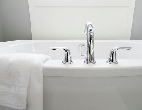A sparkling clean bathtub with shiny faucets