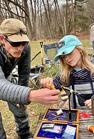 Galen teaching a child how to tie their own flies, highlighting hands-on learning and mentorship with Shenandoah Valley Adven