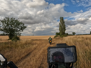 A trail bike rider checks a map in the fields
